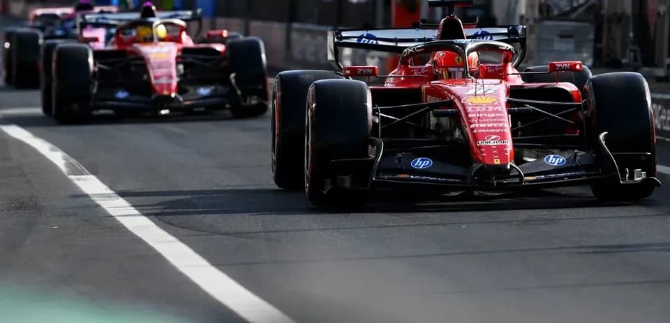 Ferrari cars driving on pit lane during race