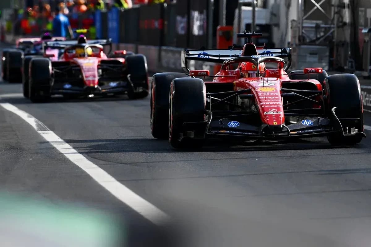 Ferrari cars driving on pit lane during race