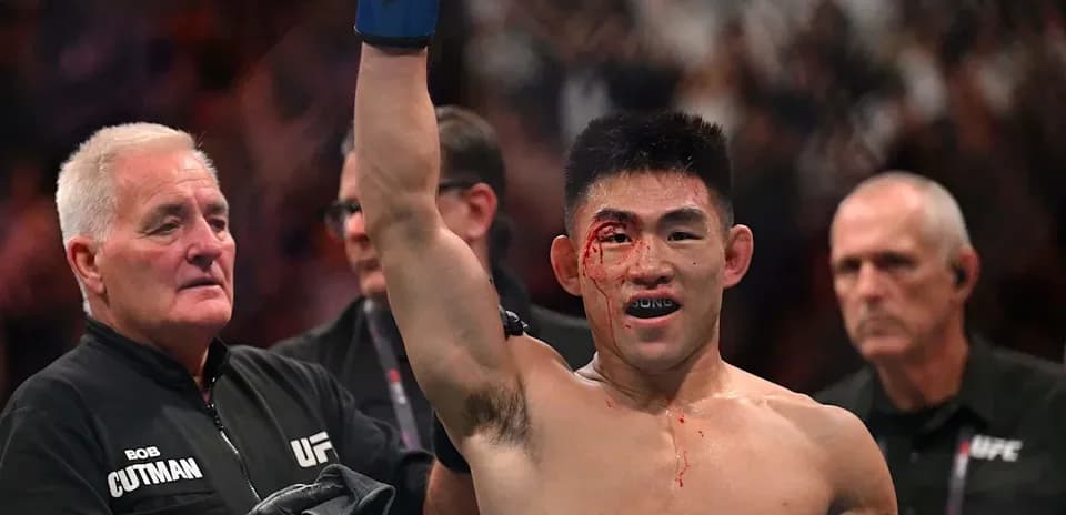 Fighter celebrating victory with blood on face