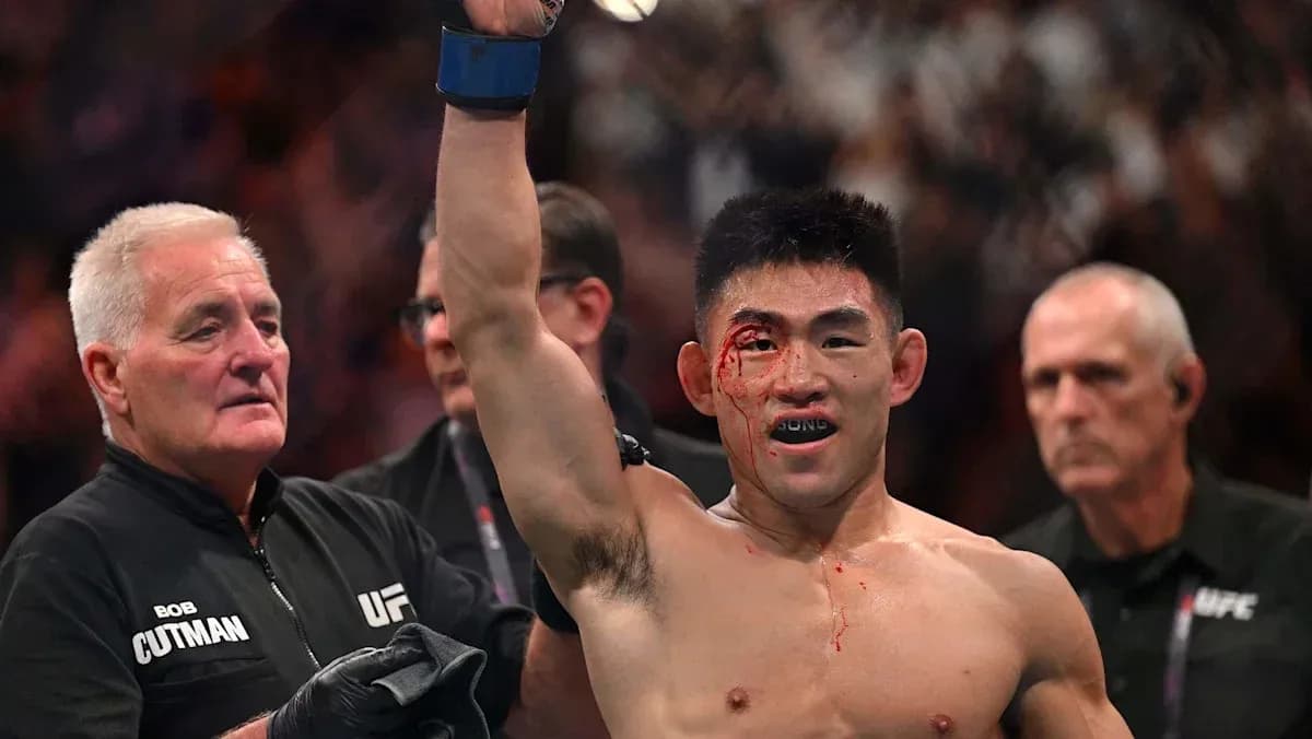 Fighter celebrating victory with blood on face