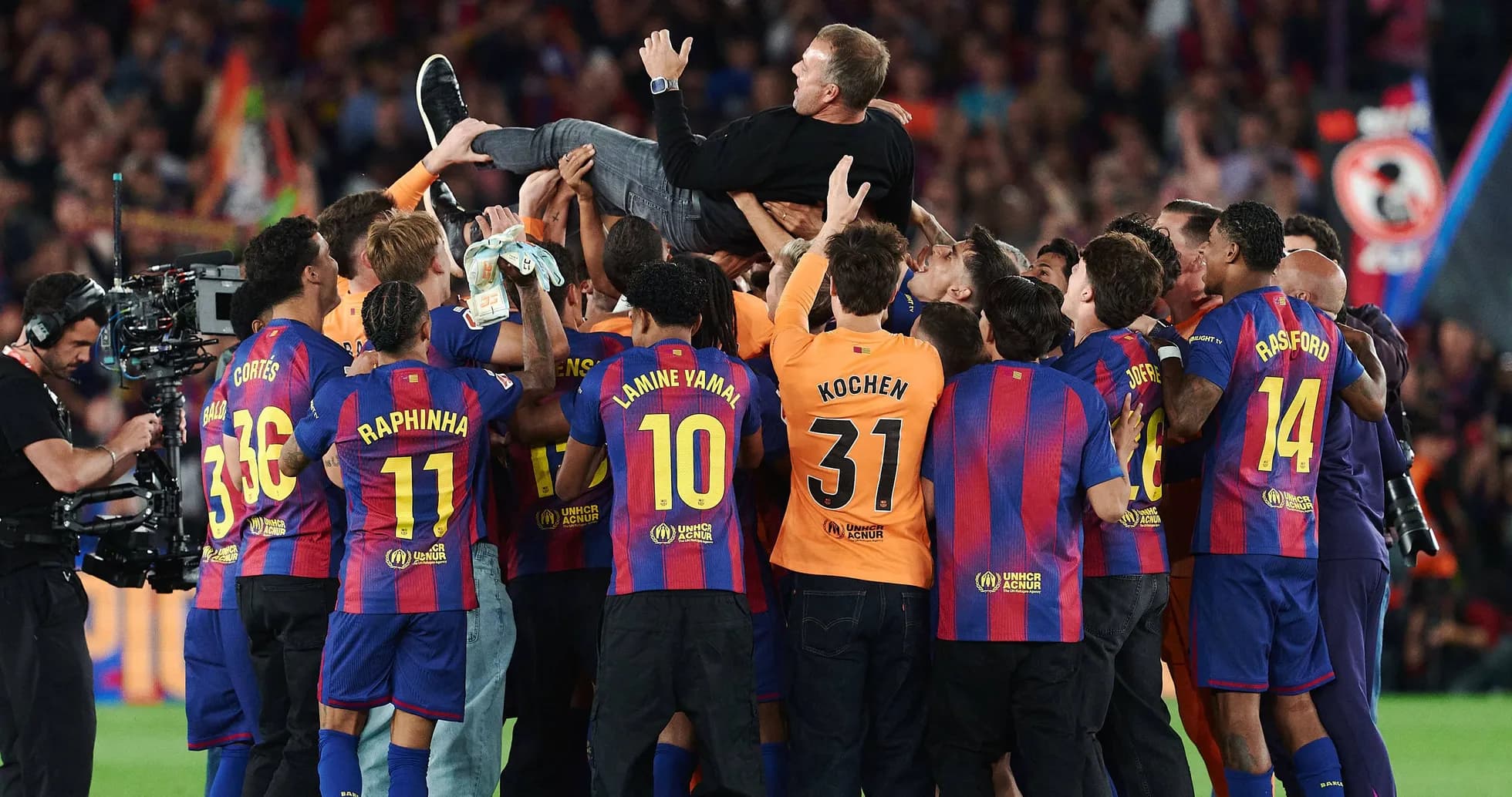 Barcelona players celebrating and lifting coach in joy