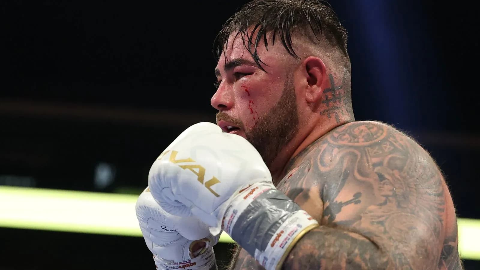 Boxer with tattoos preparing for a fight