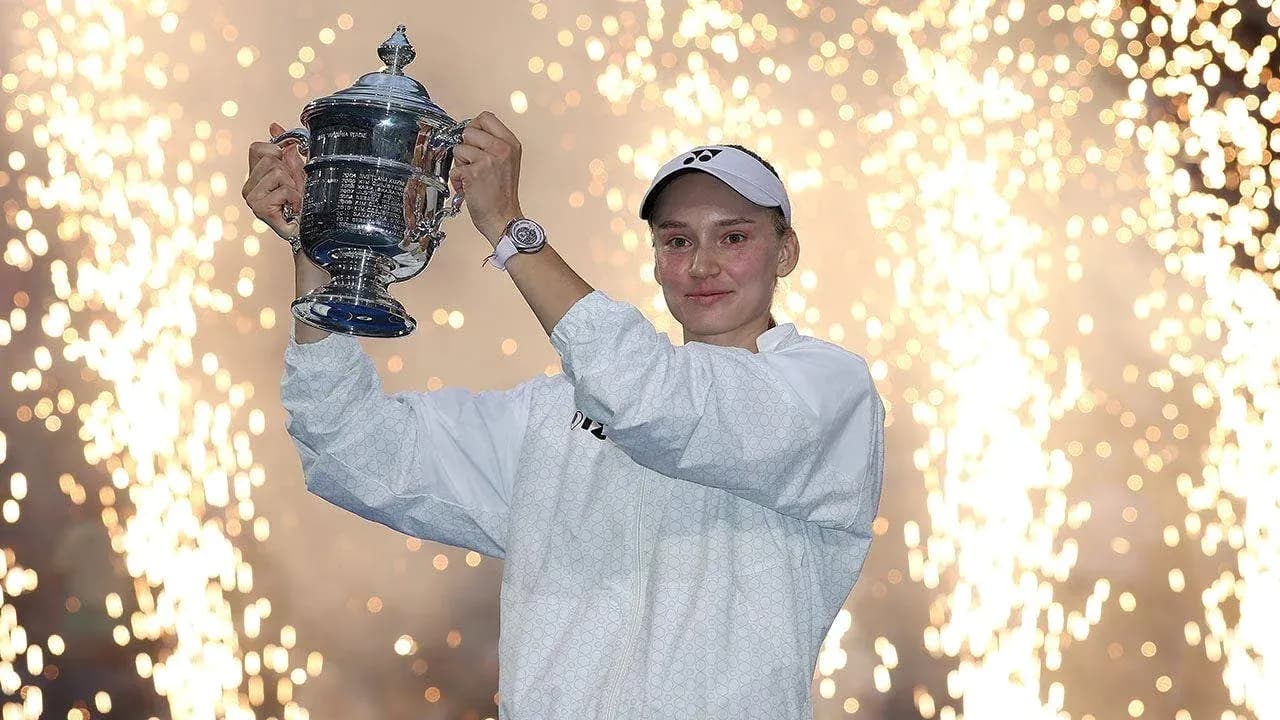 Player holding trophy with fireworks in background