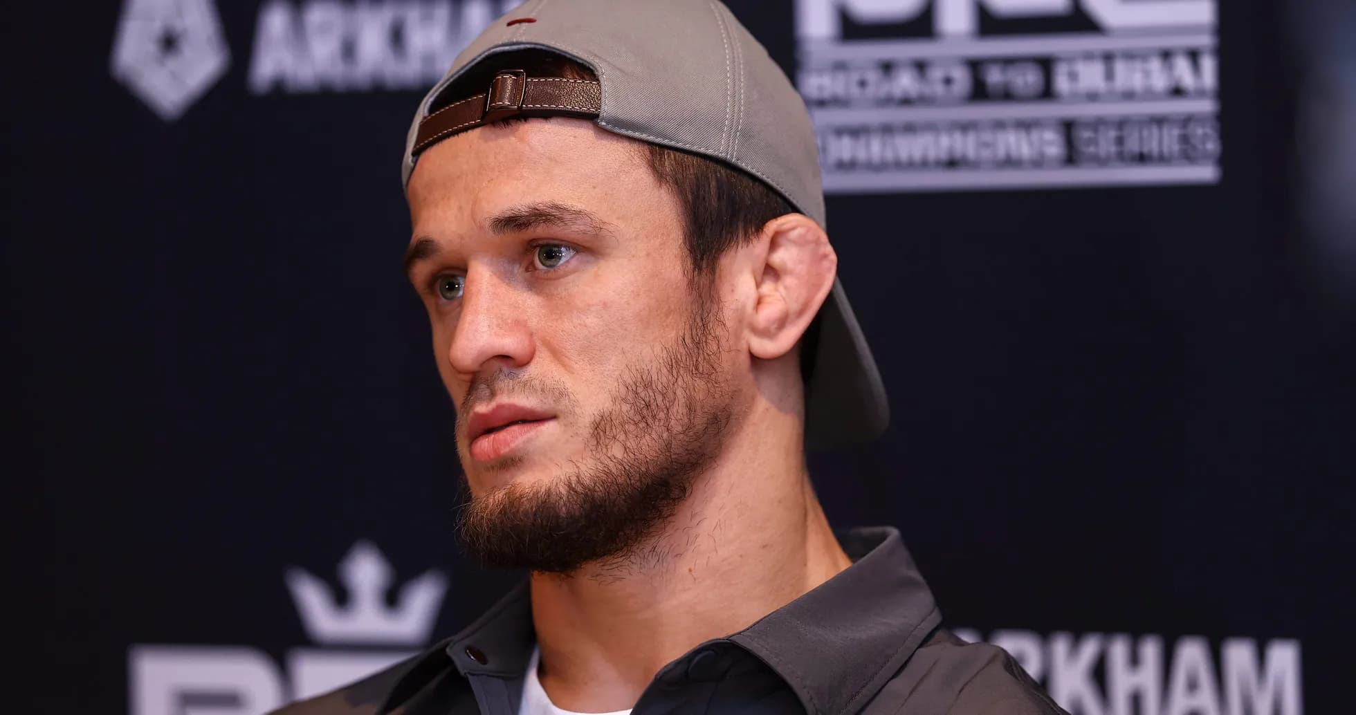 Fighter speaking at press conference with cap on