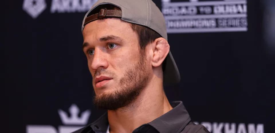 Fighter speaking at press conference with cap on
