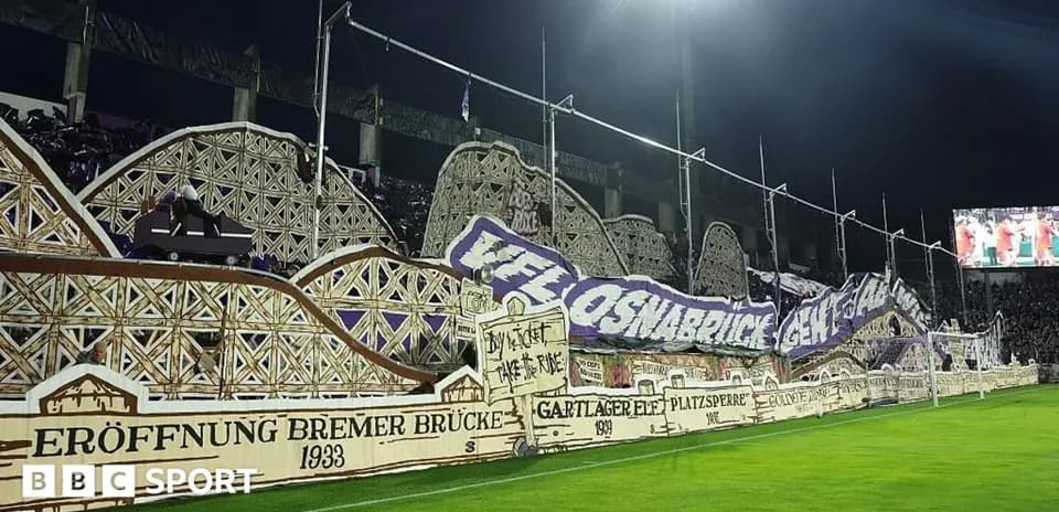 Fans displaying banners in stadium stands