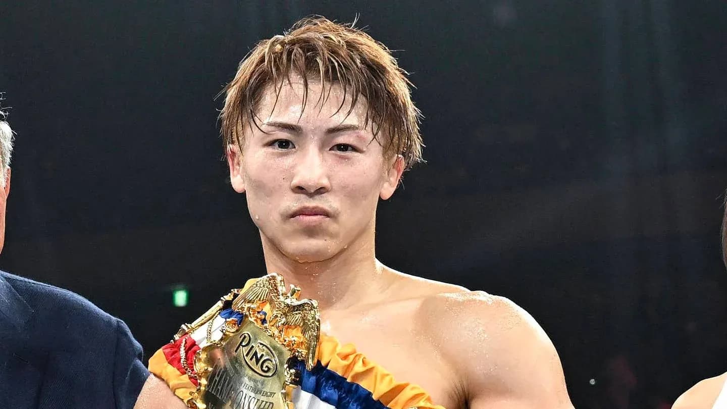 Boxer holding championship belt after victory