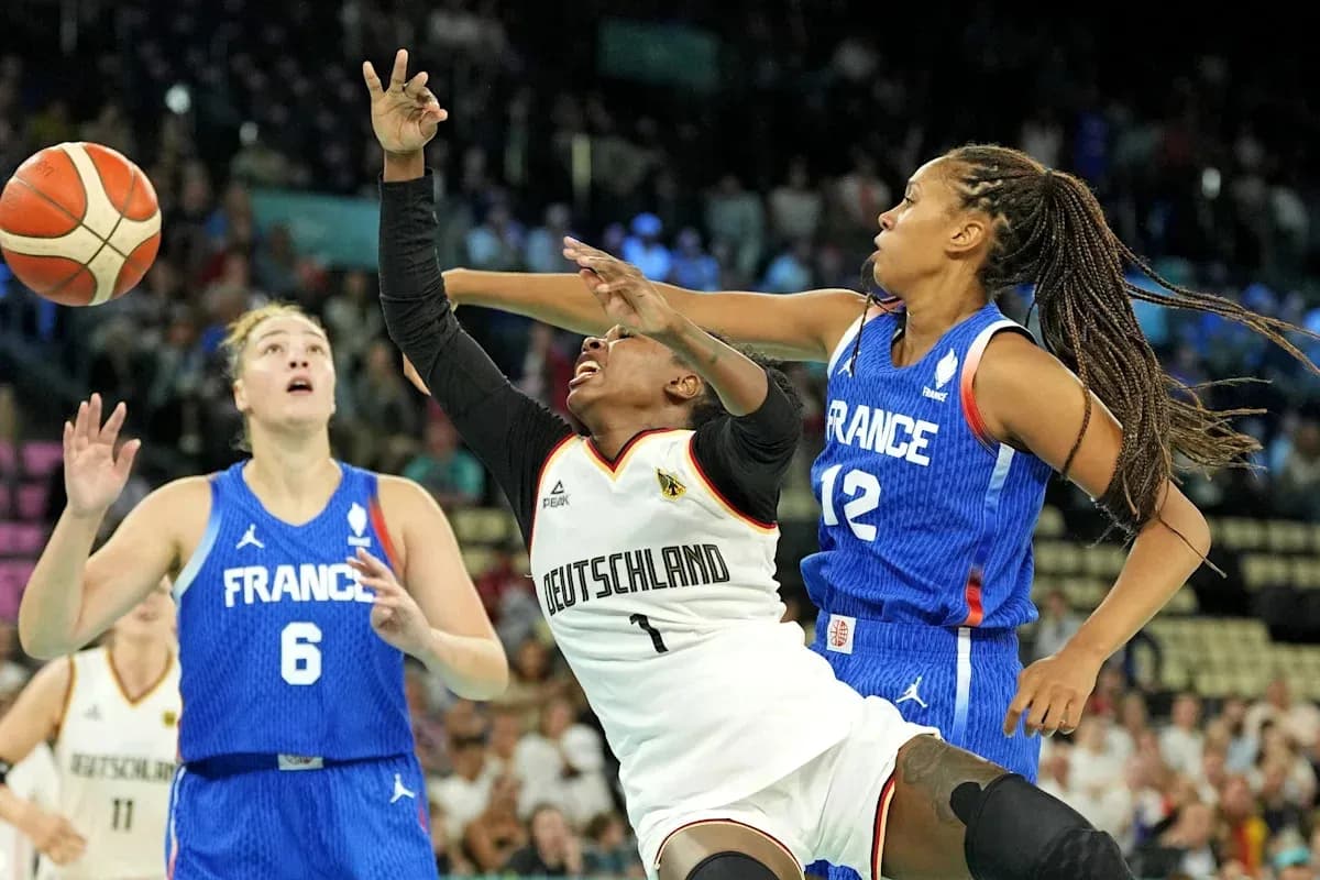 Players competing for the ball during basketball match