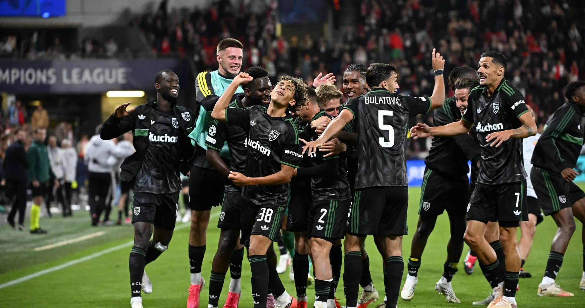 Players celebrating a goal during a Champions League match