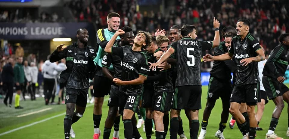 Players celebrating a goal during a Champions League match