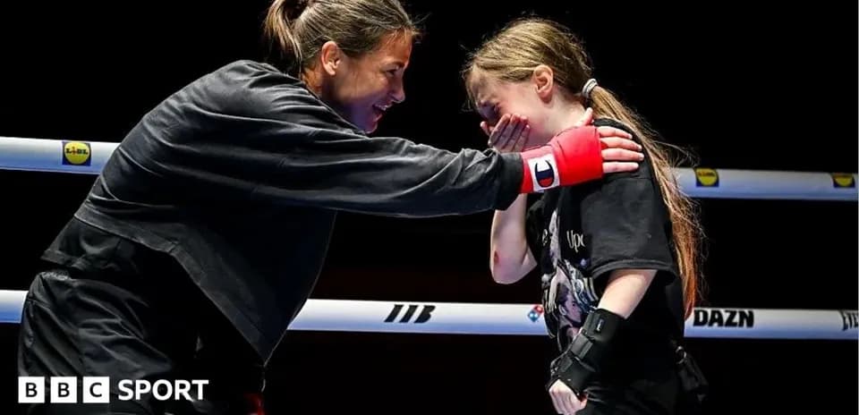 Boxer mentoring young girl in training ring