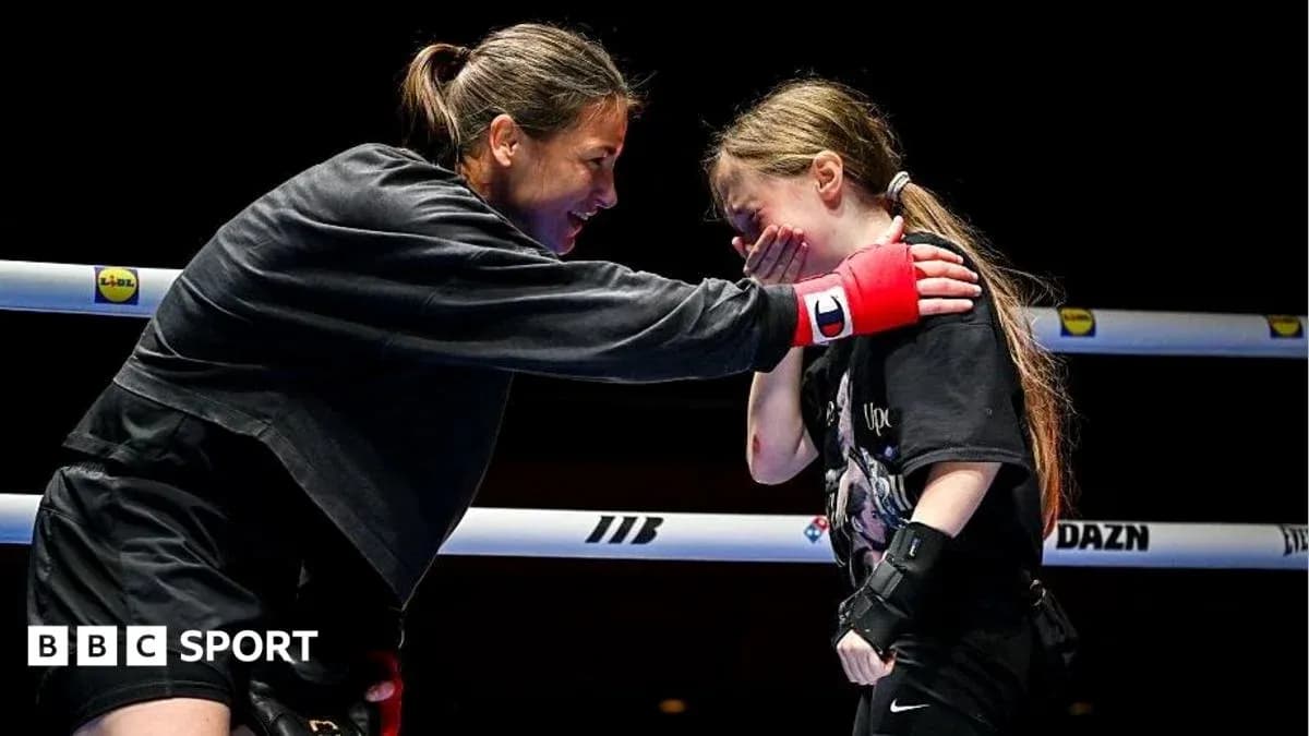 Boxer mentoring young girl in training ring