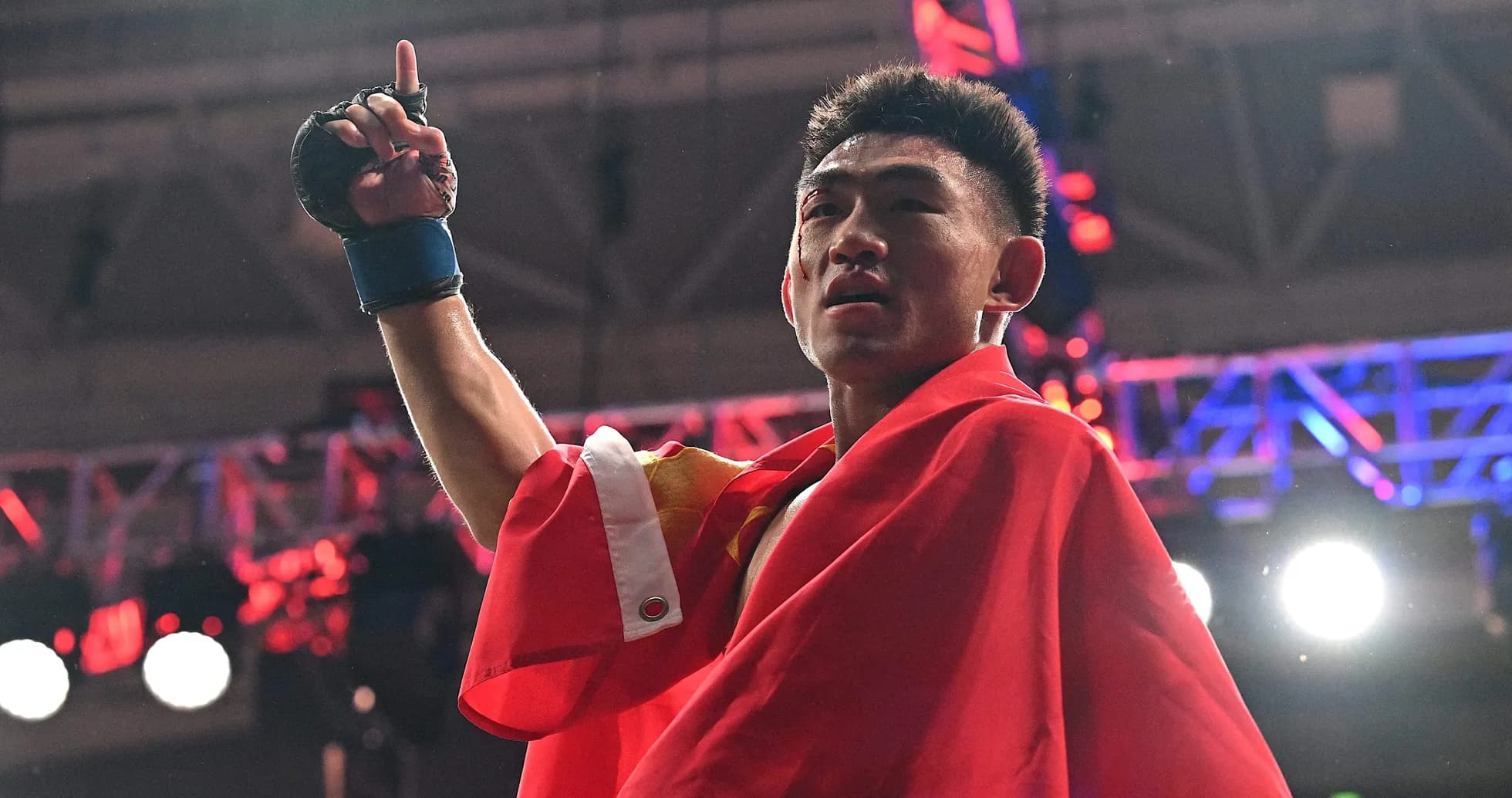 Boxer celebrating victory with raised hand and flag