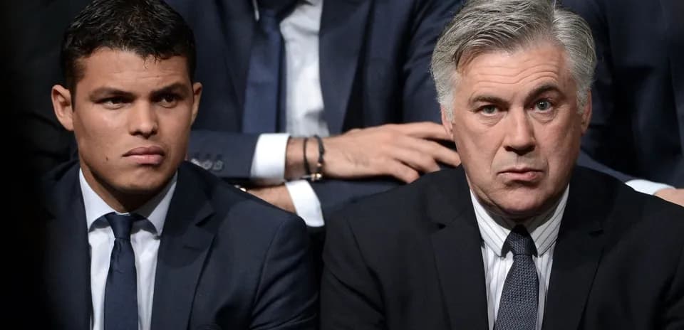 Two men in suits sitting closely together