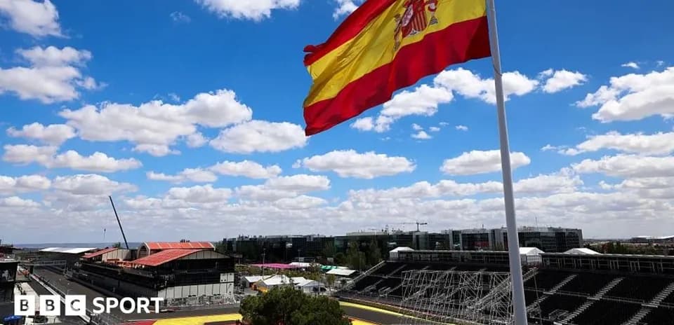 Spanish flag waving at racing circuit under blue sky