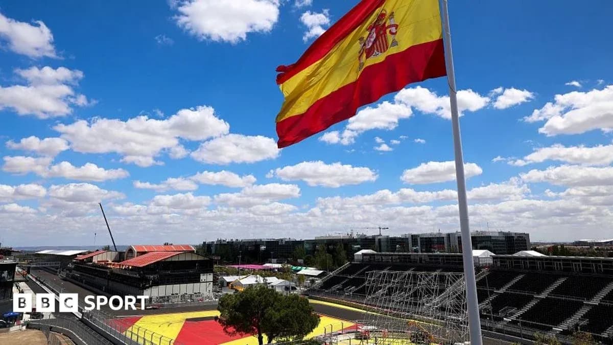 Spanish flag waving at racing circuit under blue sky