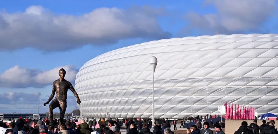 Fans gathering near stadium and statue before match