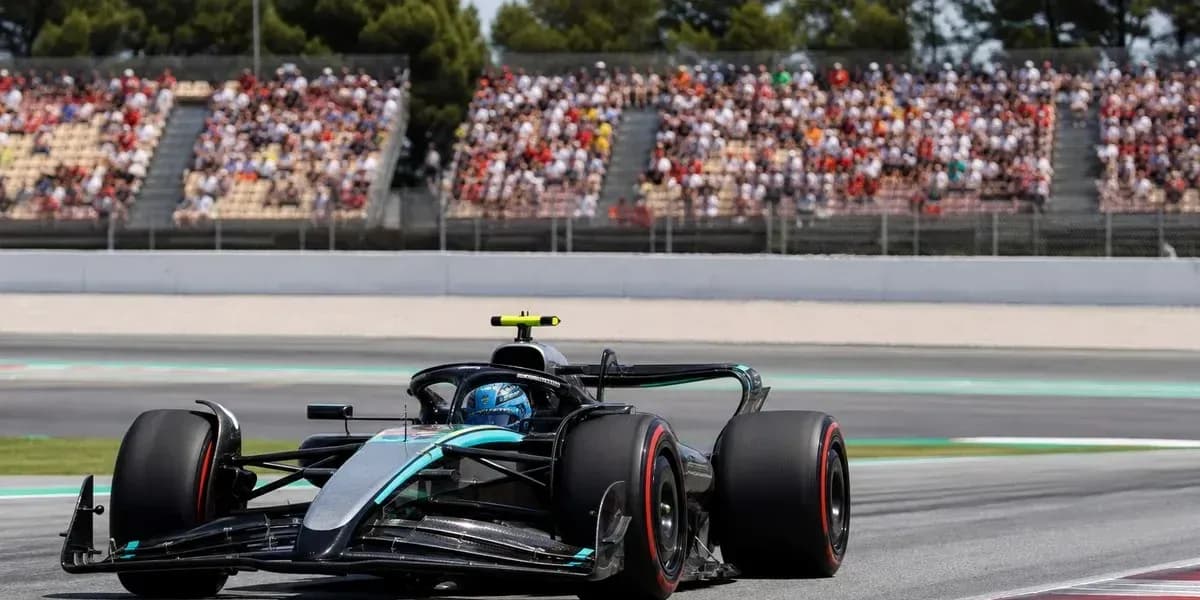 Formula 1 car racing on track with spectators in background
