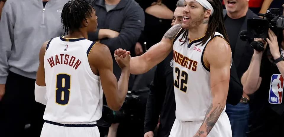 Two basketball players celebrating during a game
