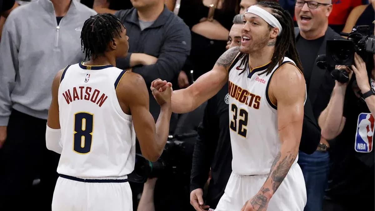Two basketball players celebrating during a game