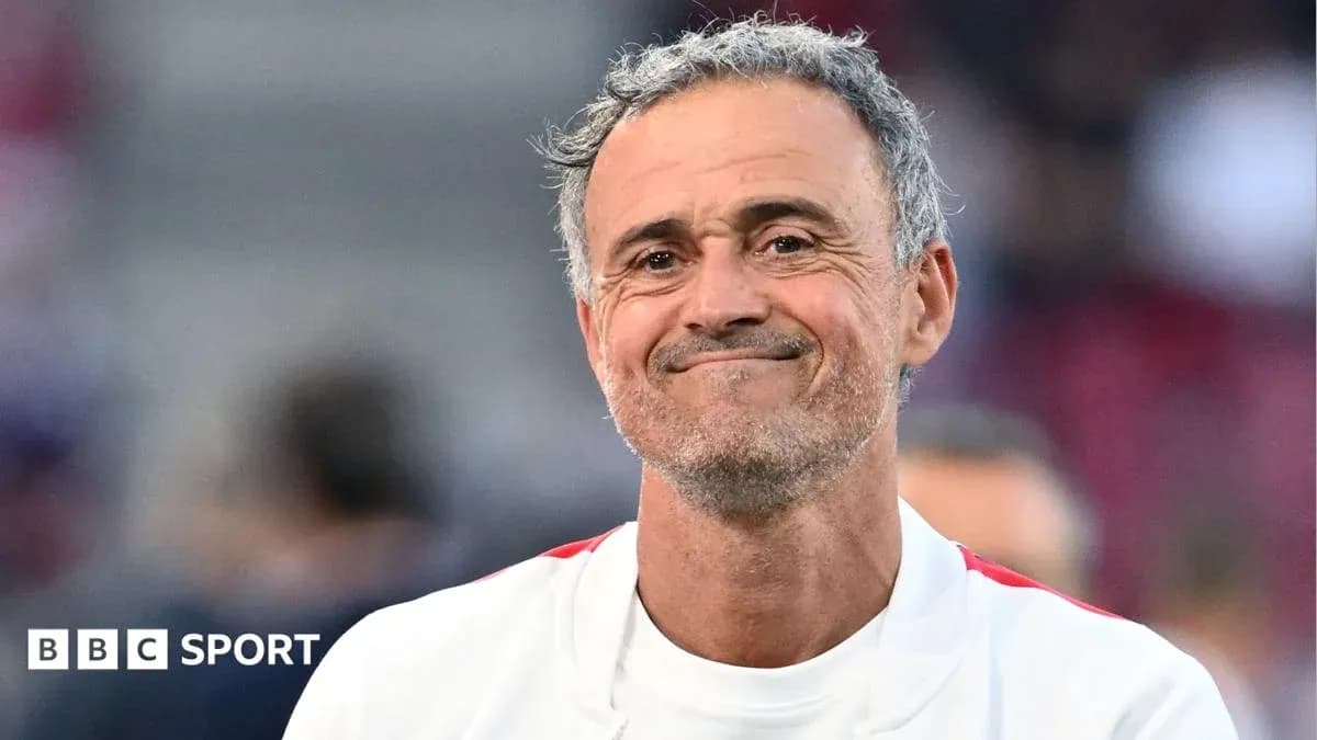 Coach smiling on the sidelines during match