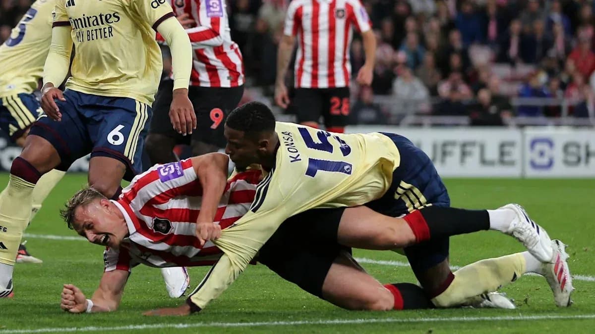 Players in a tackle during a football match