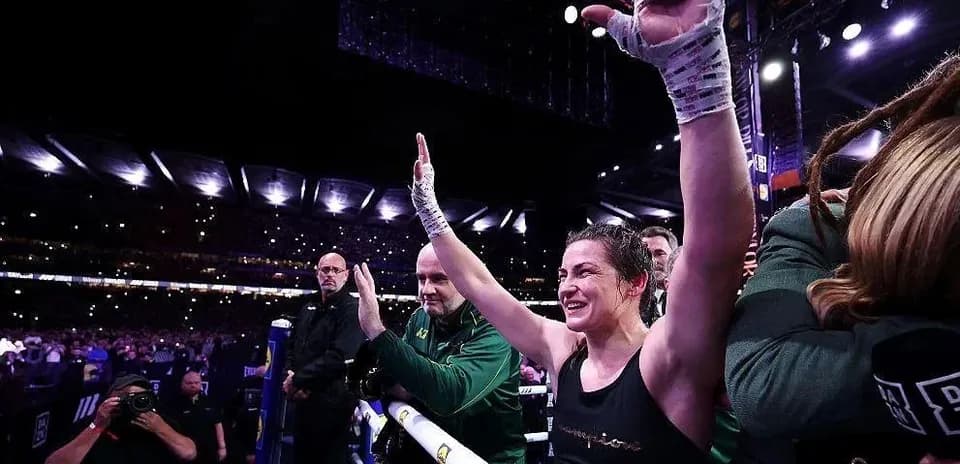 Female boxer celebrating victory in the ring