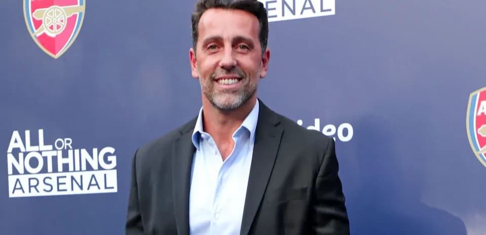 Person smiling at Arsenal event backdrop