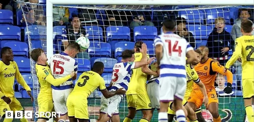 Players contesting a header near the goal line