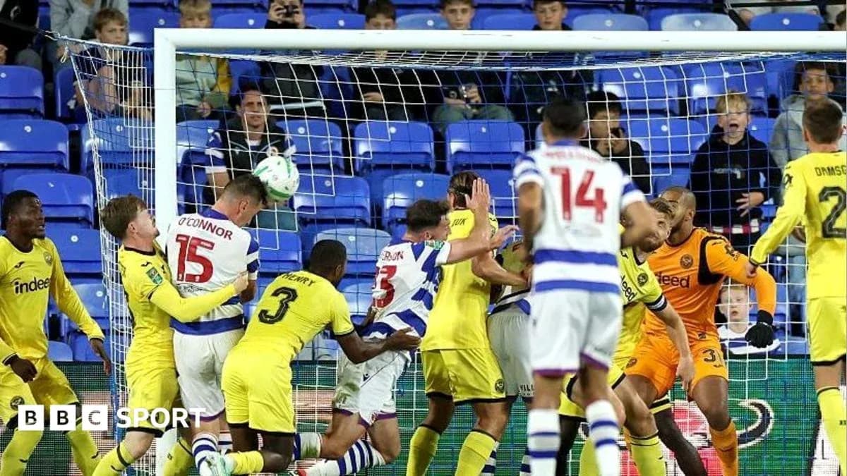 Players contesting a header near the goal line
