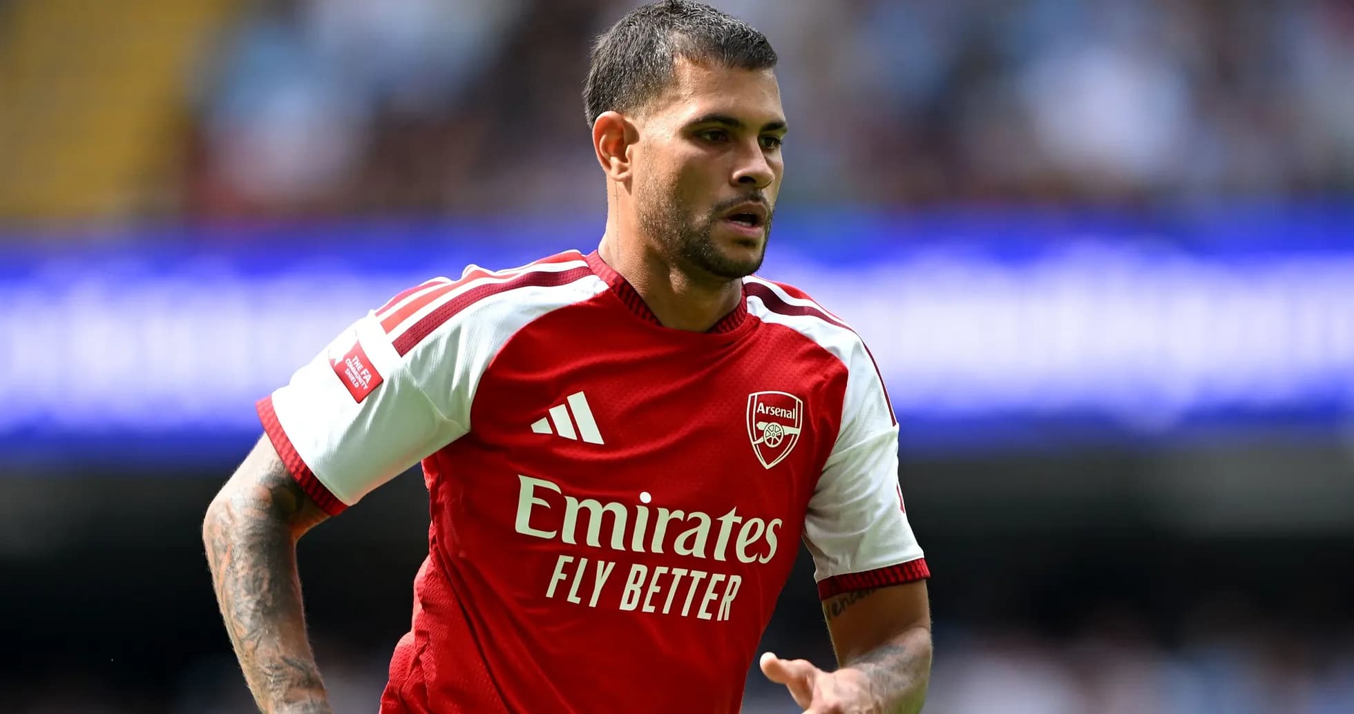 Player in Arsenal jersey running on the pitch
