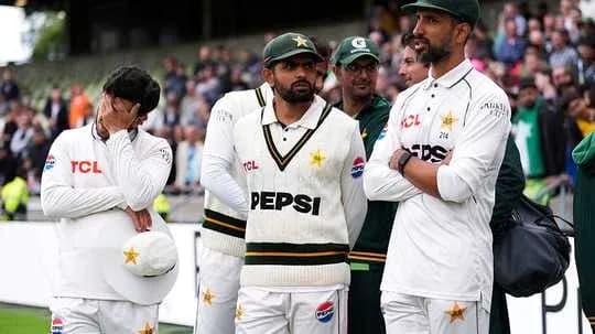 Pakistan cricket team players in white kit on field