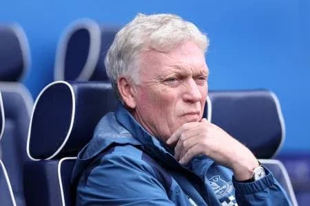 Manager seated on bench during match contemplation