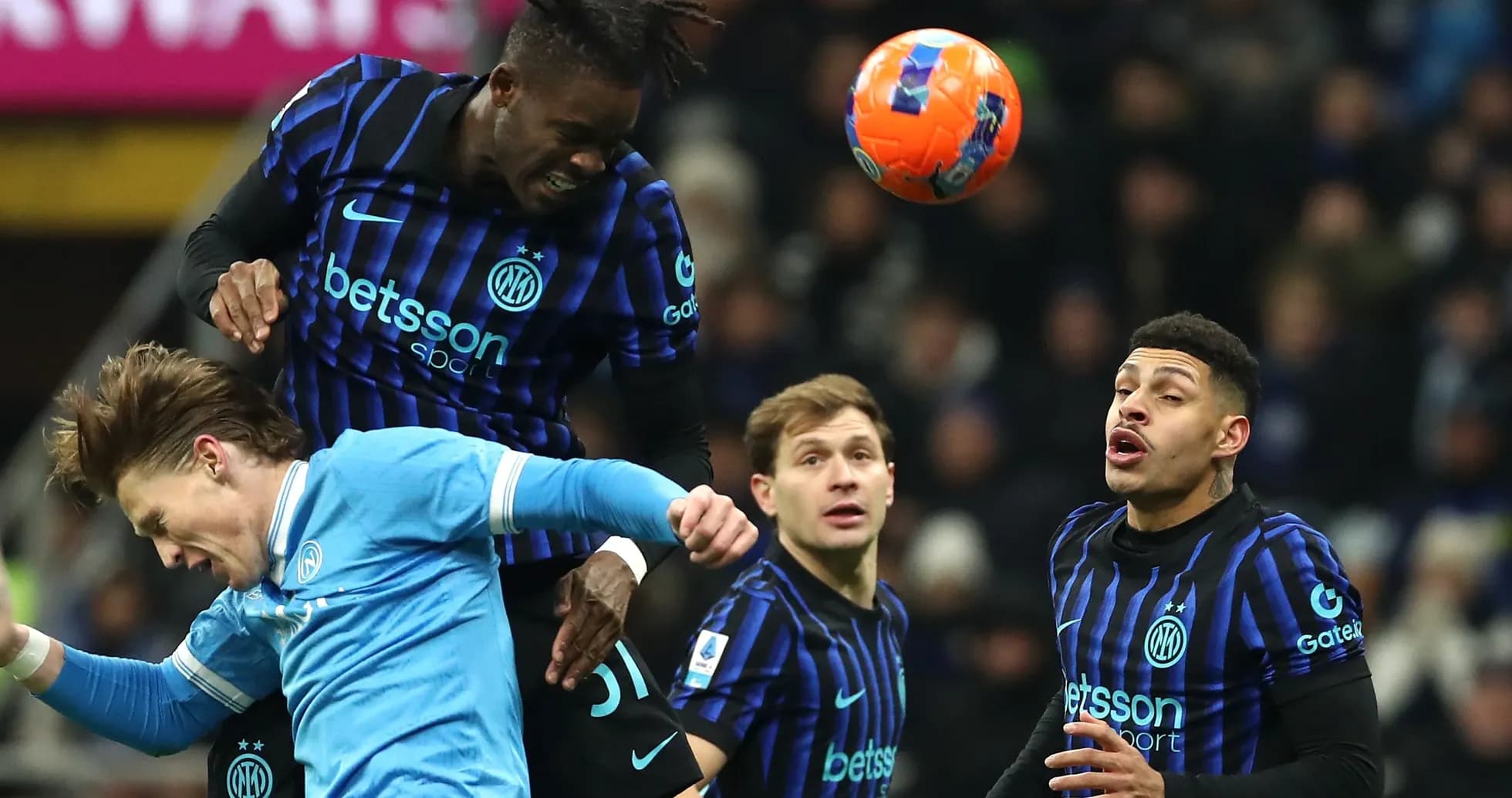 Players competing for a header during a match