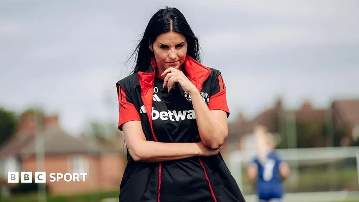 Coach observing players during training session