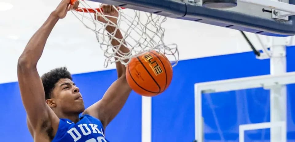 Player dunking a basketball during practice session