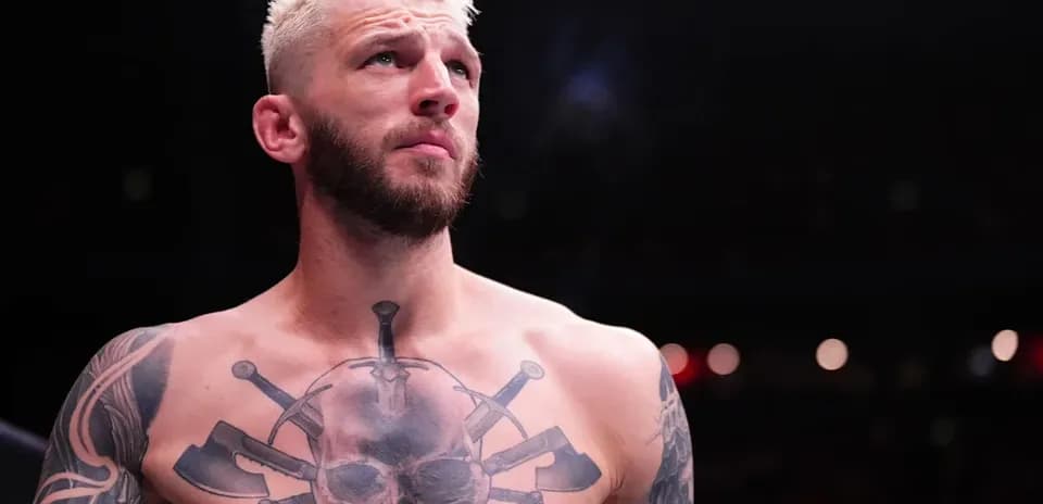Fighter with tattoos preparing in the ring