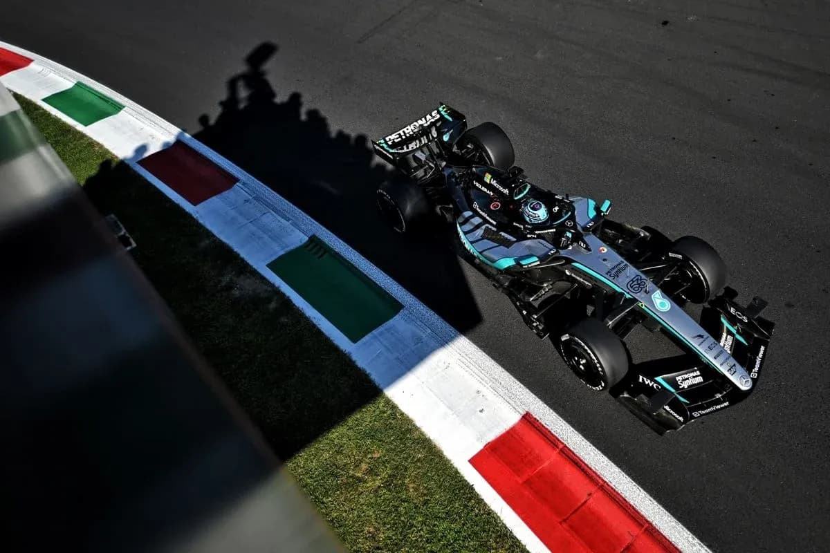 Formula 1 car navigating a track corner