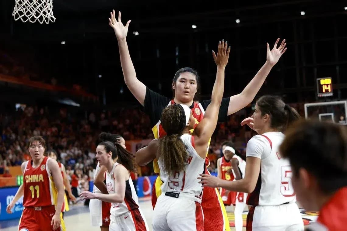 Players competing for the ball during basketball game
