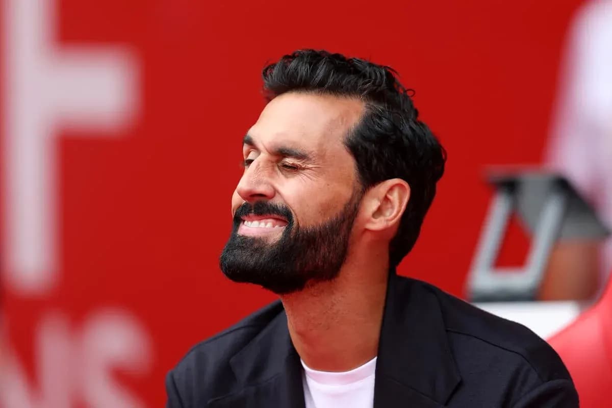 Man with beard smiling while sitting on bench