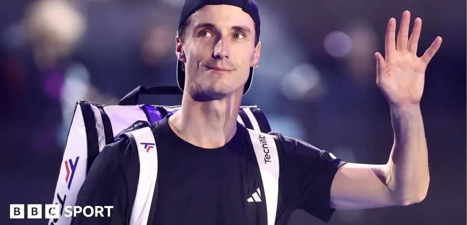 Tennis player waving with bag on shoulder