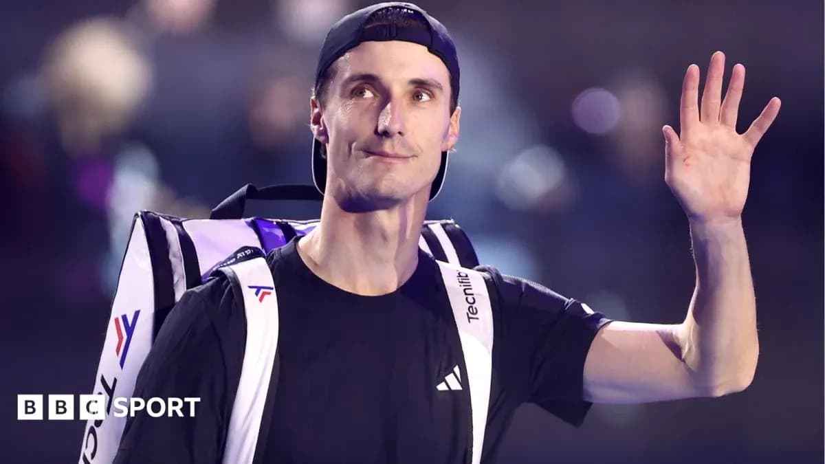 Tennis player waving with bag on shoulder