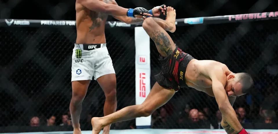 One fighter executing a takedown in the octagon