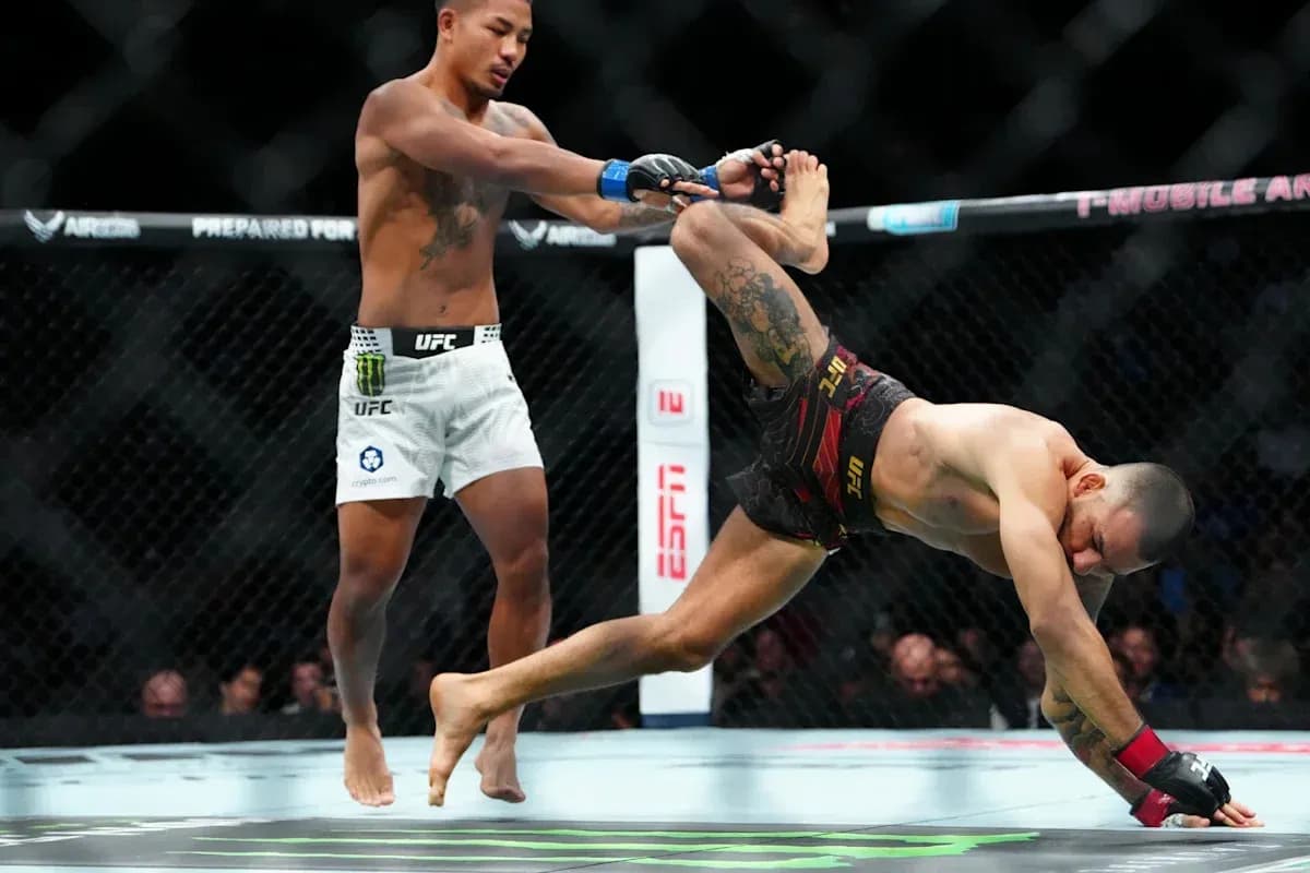 One fighter executing a takedown in the octagon
