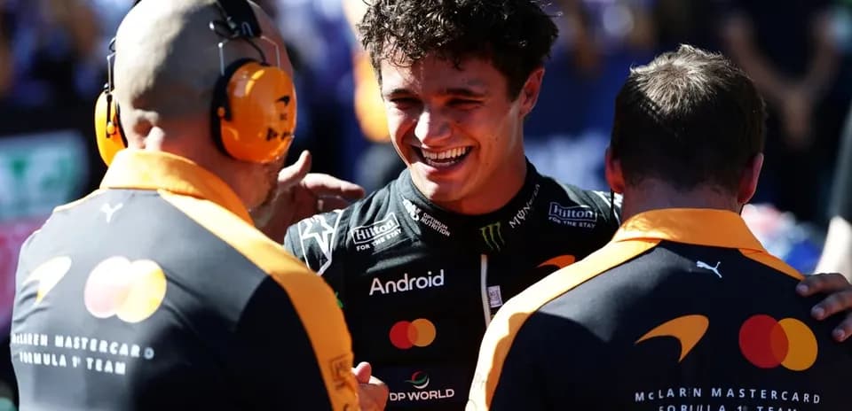Lando Norris celebrating with McLaren team members