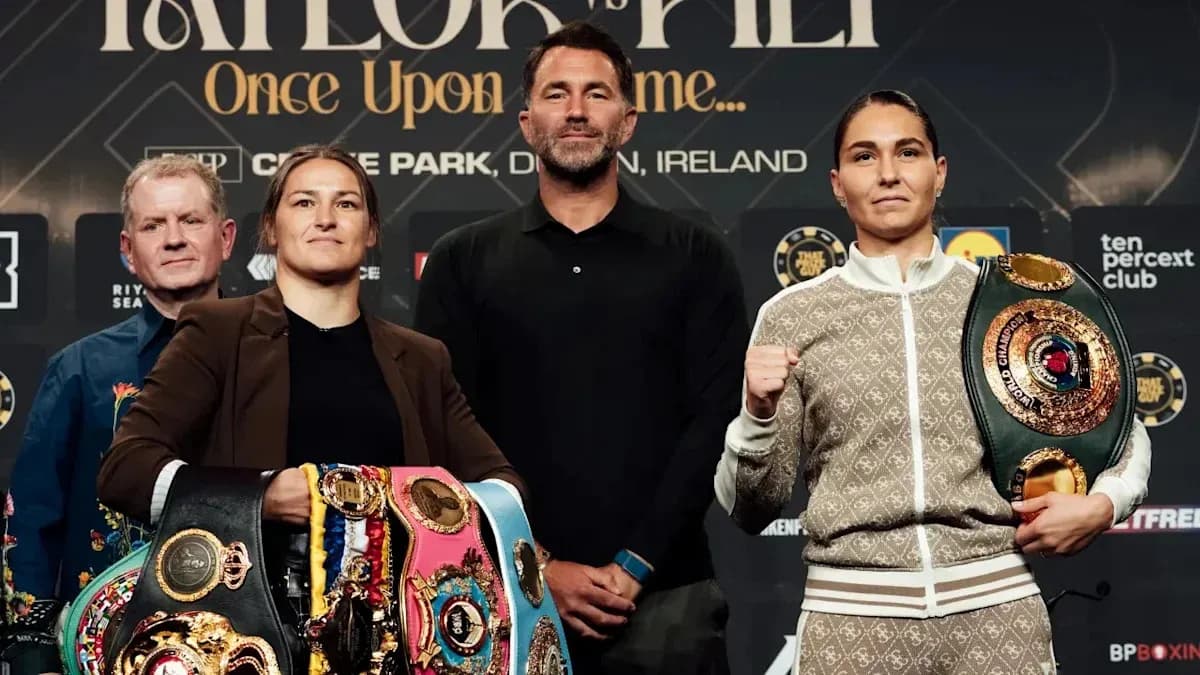 Two female boxers posing with championship belts at press event