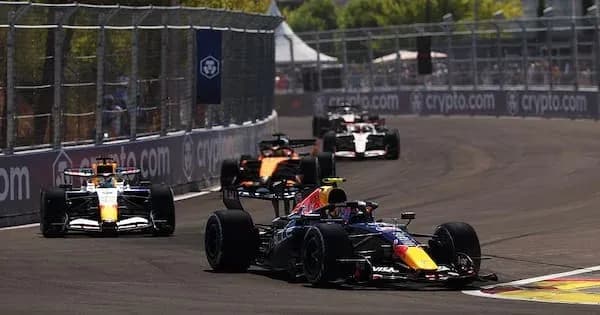 Four Formula 1 cars racing on track
