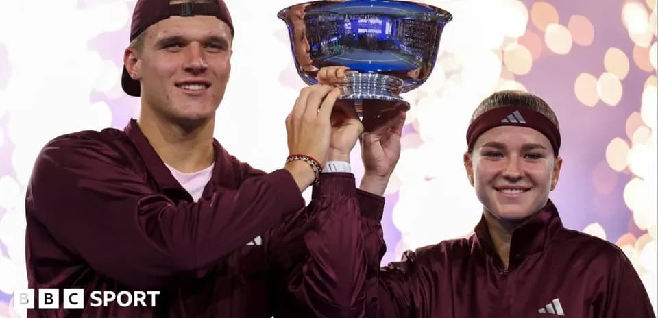 Players celebrating victory with trophy on stage