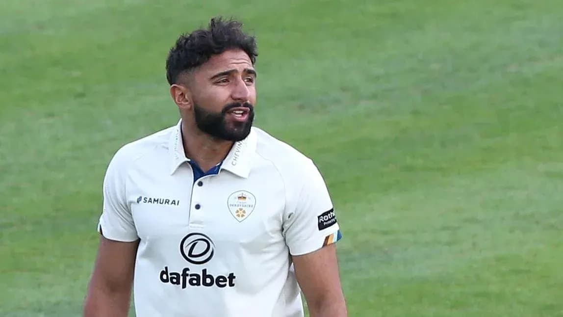 Cricketer in white kit during match on field