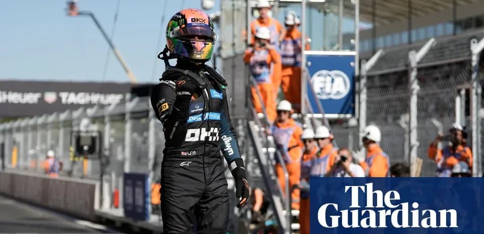 Driver celebrating after race with pit crew in background